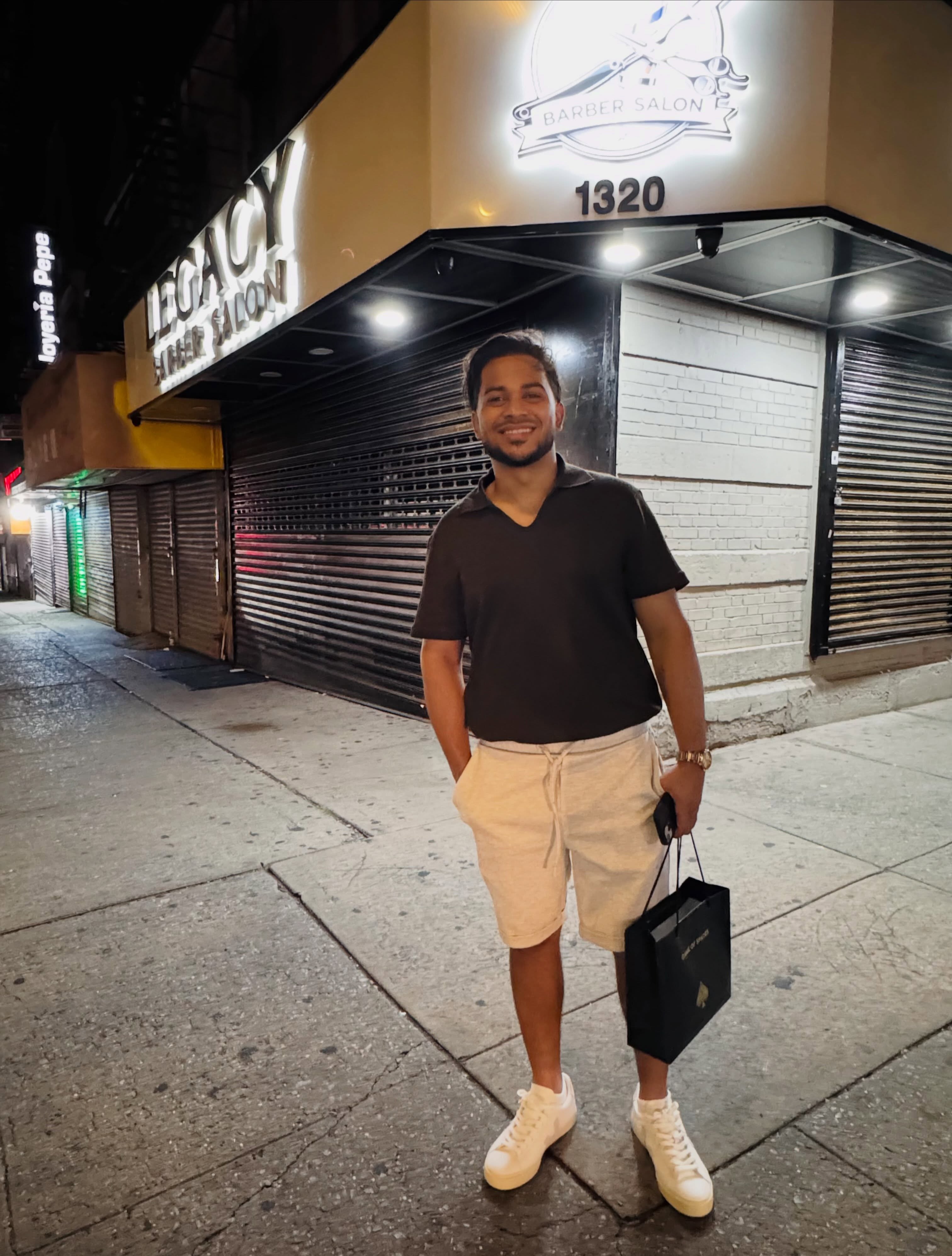Anderson Sanchez in front of Legacy Barber Salon at 1320 St Nicholas Ave, Washington Heights NYC
