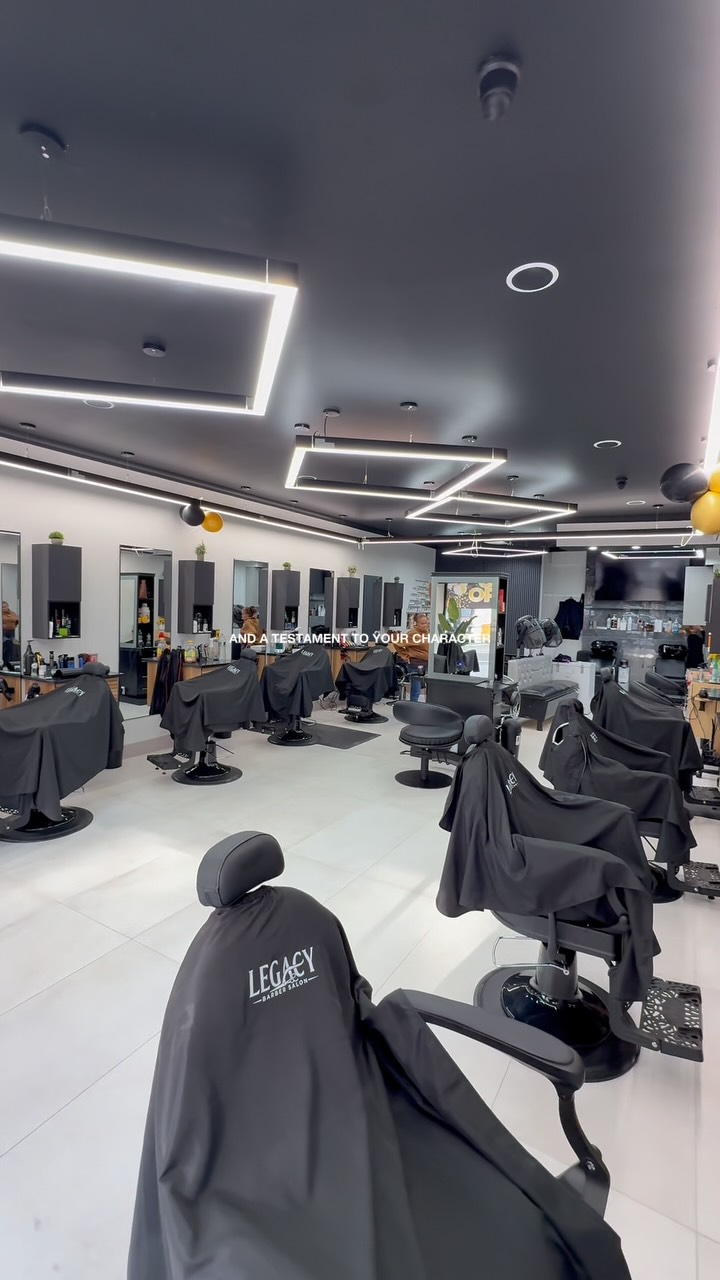 Modern black-and-white barbershop floor with LED lighting inside Legacy Barber Salon, Washington Heights NYC